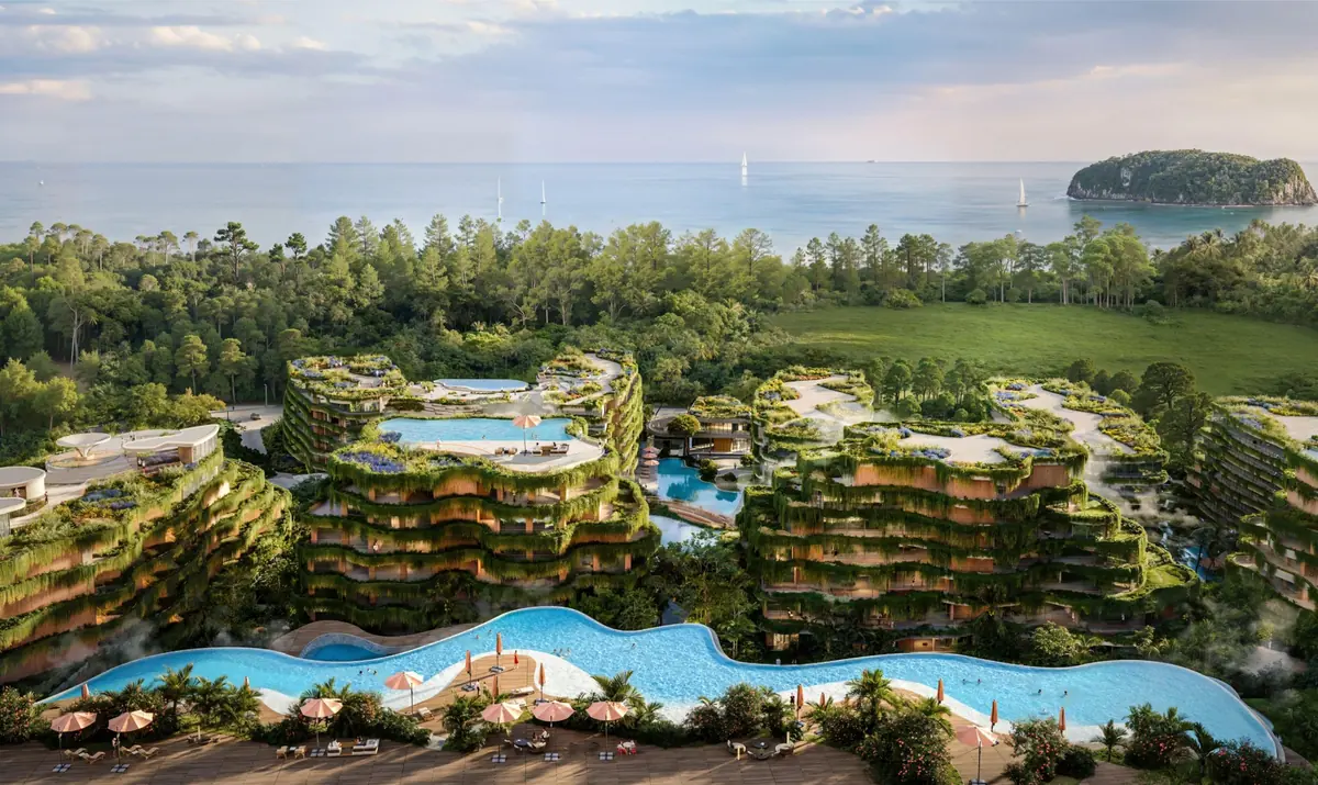 Layan Verde from above, residential buildings around landscaped pools near the sea (developer render)